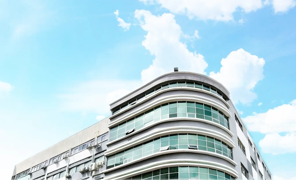 Company building exterior shown against a clear sky