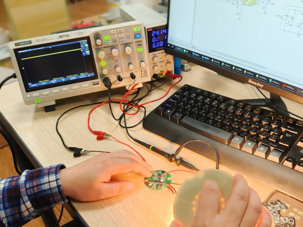 Engineer performing design verification on LED driver and light board at workbench