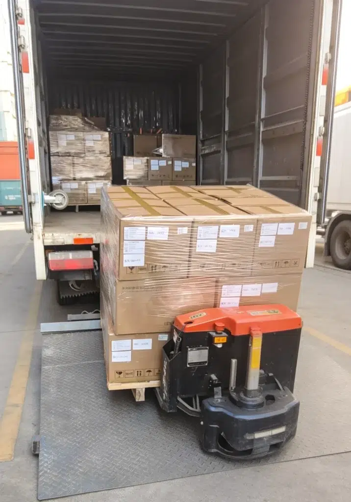 Loading cartons of LED goods onto truck for customer delivery