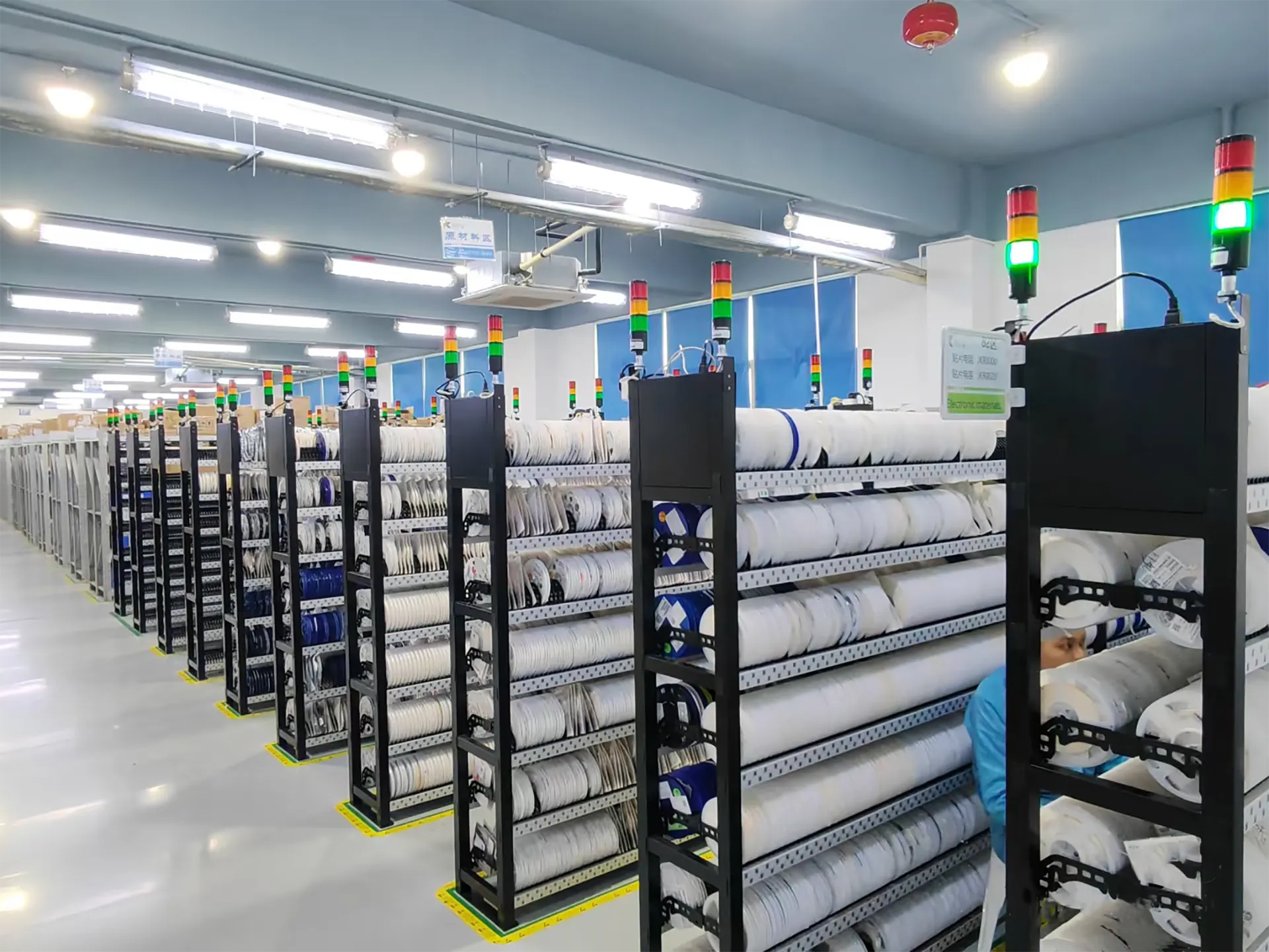 Multiple warehouse racks stocked with electronic components and materials