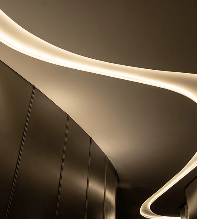Flexible LED strip light installed on ceiling for ambient indirect lighting